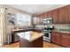 Well-lit kitchen features granite countertops, stainless steel appliances, and wooden cabinetry at 9290 Melborne Ct, Parker, CO 80134