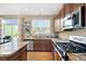 Modern kitchen with stainless steel appliances, granite countertops, island, and natural light at 9290 Melborne Ct, Parker, CO 80134