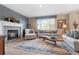 Cozy living room featuring a fireplace, comfortable seating, and natural light at 9290 Melborne Ct, Parker, CO 80134
