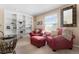 Inviting loft area with comfortable red chairs, built-in shelving, and natural light at 9290 Melborne Ct, Parker, CO 80134