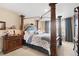 Luxurious bedroom features a four-poster bed, dark wood furniture, and soft, neutral decor at 9290 Melborne Ct, Parker, CO 80134
