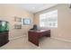 Bright office space featuring a dark wood desk, neutral walls, and a large window for natural light at 9290 Melborne Ct, Parker, CO 80134