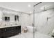 Modern bathroom with marble walls, soaker tub, and walk-in shower with black hardware at 2140 Tabor Dr, Lakewood, CO 80215