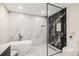 Elegant bathroom featuring marble accents, a freestanding tub, and a sleek glass-enclosed shower at 2140 Tabor Dr, Lakewood, CO 80215