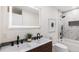 Stylish bathroom featuring a double vanity, illuminated mirror, and a shower with black hardware at 2140 Tabor Dr, Lakewood, CO 80215
