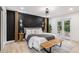 Contemporary bedroom with a black accent wall, wooden details, and sliding doors to the outdoors at 2140 Tabor Dr, Lakewood, CO 80215