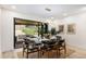 Open dining room features sleek furnishings and bi-fold doors to outdoor living space at 2140 Tabor Dr, Lakewood, CO 80215