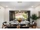 Dining room flows into a covered patio through bi-fold doors for seamless indoor-outdoor living at 2140 Tabor Dr, Lakewood, CO 80215
