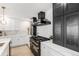Gourmet kitchen featuring a luxury range and hood, custom cabinets, and quartz countertops at 2140 Tabor Dr, Lakewood, CO 80215