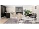 Open living space with bar seating, fireplace, and modern furniture at 2140 Tabor Dr, Lakewood, CO 80215