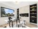 Bright home office featuring a modern fireplace and custom shelving at 2140 Tabor Dr, Lakewood, CO 80215