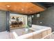 Inviting outdoor patio with comfortable seating area flows from dining and kitchen areas at 2140 Tabor Dr, Lakewood, CO 80215