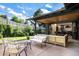 Cozy outdoor patio with comfortable seating and a view of the lush backyard at 2140 Tabor Dr, Lakewood, CO 80215