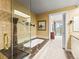 Bathroom featuring a soaking tub, tiled surround, and an entrance to the main bedroom at 400 E 3Rd Ave # 305, Denver, CO 80203