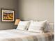 Comfortable bedroom with large pillows, neutral walls, and soft lighting at 400 E 3Rd Ave # 305, Denver, CO 80203
