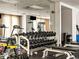 A modern gym showcasing a variety of dumbbells, weight benches, and mirrors for a comprehensive fitness experience at 400 E 3Rd Ave # 305, Denver, CO 80203