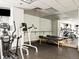 A clean gym with modern equipment including an elliptical machine, weight machines and mirrored wall accents at 400 E 3Rd Ave # 305, Denver, CO 80203