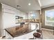 Charming kitchen features white cabinetry, granite countertops, stainless steel appliances, and a breakfast bar with seating at 400 E 3Rd Ave # 305, Denver, CO 80203