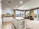 Bright, open kitchen with an island, stainless steel appliances, and seamless access to a living space and balcony at 400 E 3Rd Ave # 305, Denver, CO 80203