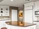 Spacious kitchen features white cabinetry, granite countertops, stainless steel appliances, and a breakfast bar with seating at 400 E 3Rd Ave # 305, Denver, CO 80203