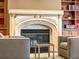 Cozy living room with a decorative fireplace, flanked by matching chairs and built-in bookcases at 400 E 3Rd Ave # 305, Denver, CO 80203
