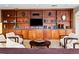 Welcoming lounge area featuring built-in shelving, TV, and comfortable seating at 400 E 3Rd Ave # 305, Denver, CO 80203