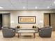 Comfortable lounge area featuring a neutral sofa, gray armchairs and a decorative wall hanging at 400 E 3Rd Ave # 305, Denver, CO 80203