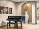 Elegant piano room featuring a grand piano, unique wall art, and decorative niche at 400 E 3Rd Ave # 305, Denver, CO 80203