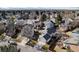 Aerial view of the property in a mature neighborhood, showcasing landscaping and nearby streets at 4493 Dunkirk Way, Denver, CO 80249