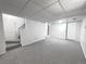 Finished basement with carpet, staircase, and door, offering flexible space at 4493 Dunkirk Way, Denver, CO 80249