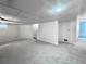 Spacious finished basement featuring neutral carpeting, bright lighting, and potential for flexible use at 4493 Dunkirk Way, Denver, CO 80249
