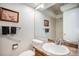 Bathroom featuring a single sink, large mirror, and a walk-in shower with accessibility hand rail at 4493 Dunkirk Way, Denver, CO 80249
