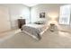 Bright bedroom with neutral carpet, closet and a large window providing ample natural light at 4493 Dunkirk Way, Denver, CO 80249