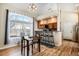 Eat-in kitchen features an oversized window, a breakfast bar, and a dining table for casual dining at 4493 Dunkirk Way, Denver, CO 80249