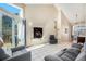 Bright living room with tile flooring, fireplace, tall ceilings, and large sliding door access to deck at 4493 Dunkirk Way, Denver, CO 80249