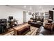 Finished basement with large seating area, desk, and tiled flooring at 7891 Poplar St, Commerce City, CO 80022