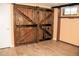 Basement featuring sliding barn doors and vinyl floors at 7891 Poplar St, Commerce City, CO 80022