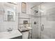Bathroom with marble-tiled walk-in shower, modern fixtures, and glass door at 7891 Poplar St, Commerce City, CO 80022