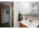 Well-lit bathroom featuring a decorative tile backsplash, and updated fixtures at 7891 Poplar St, Commerce City, CO 80022