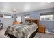 Bedroom with neutral colored walls, carpeted flooring, and a large wood headboard bedframe at 7891 Poplar St, Commerce City, CO 80022