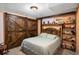Cozy bedroom featuring rustic wooden barn doors, built-in shelving and decor at 7891 Poplar St, Commerce City, CO 80022