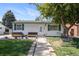 Charming single-story home with well-maintained lawn and inviting benches on front porch at 7891 Poplar St, Commerce City, CO 80022