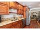 Kitchen with granite countertops, stainless steel appliances, and open view to the living room at 7891 Poplar St, Commerce City, CO 80022