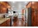 Kitchen featuring stainless steel appliances, wood cabinets, and dining area near backdoor at 7891 Poplar St, Commerce City, CO 80022