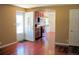 Open-concept living room showcasing hardwood floors with a partial view of the modern kitchen at 7891 Poplar St, Commerce City, CO 80022