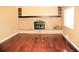 Cozy living room featuring a brick fireplace and hardwood floors at 7891 Poplar St, Commerce City, CO 80022