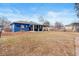 Backyard view showcasing the blue house with a covered patio and large outdoor space at 3080 S Eudora St, Denver, CO 80222