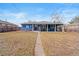 View of the backyard showing the blue house, covered patio, and walkway to the house at 3080 S Eudora St, Denver, CO 80222