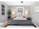 Inviting bedroom featuring hardwood floors, soft gray walls, and a comfortable queen-sized bed at 3080 S Eudora St, Denver, CO 80222