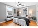 Sunlit bedroom showcasing hardwood floors, neutral walls, and a comfortable queen-sized bed at 3080 S Eudora St, Denver, CO 80222